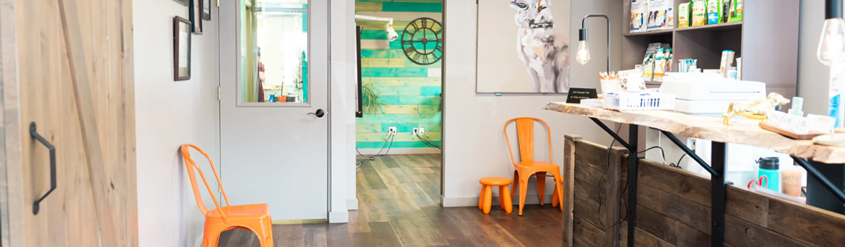 Lobby area with front reception desk and orange chairs for waiting